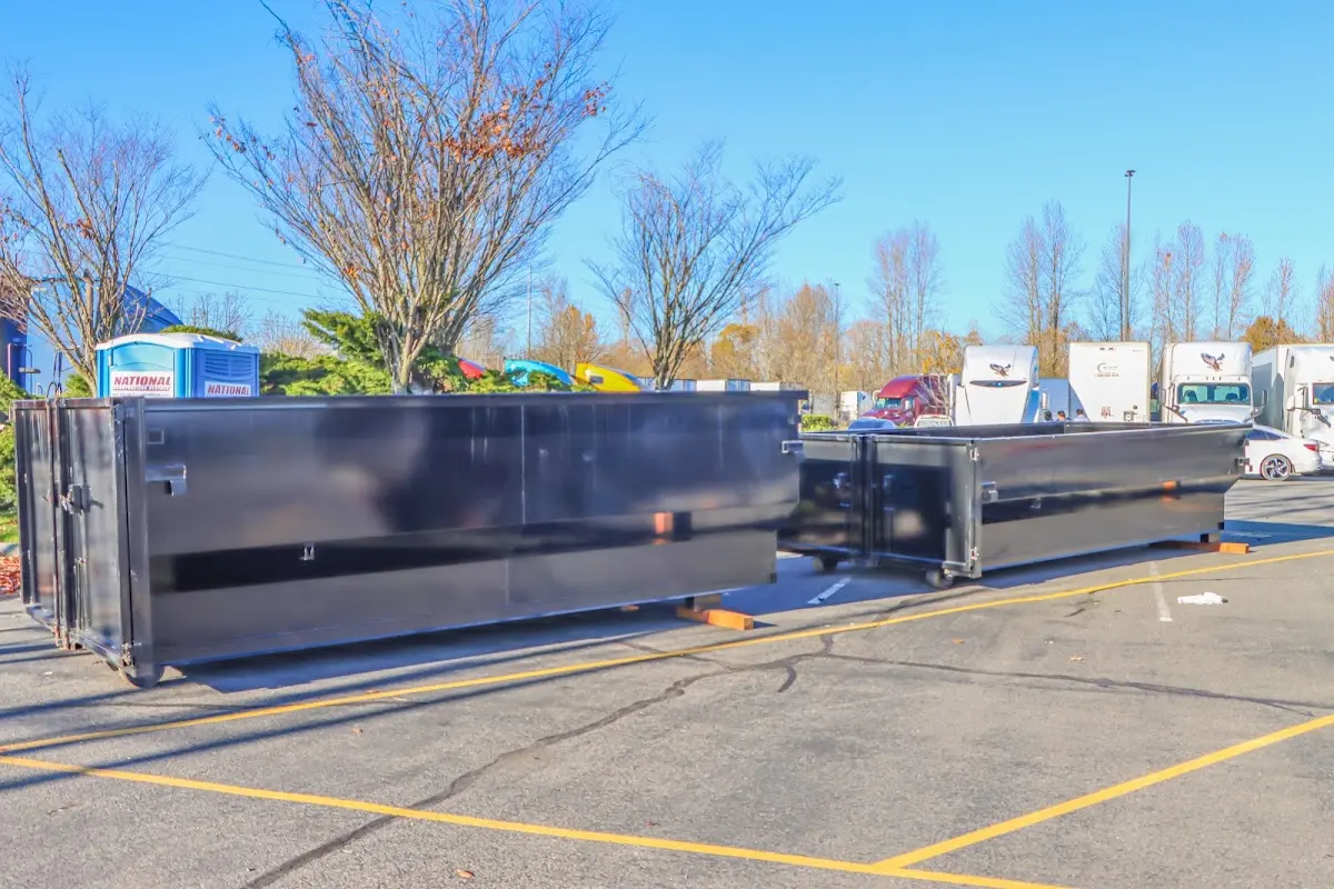 Professional dumpster rental service with roll-off container on residential driveway in South Euclid